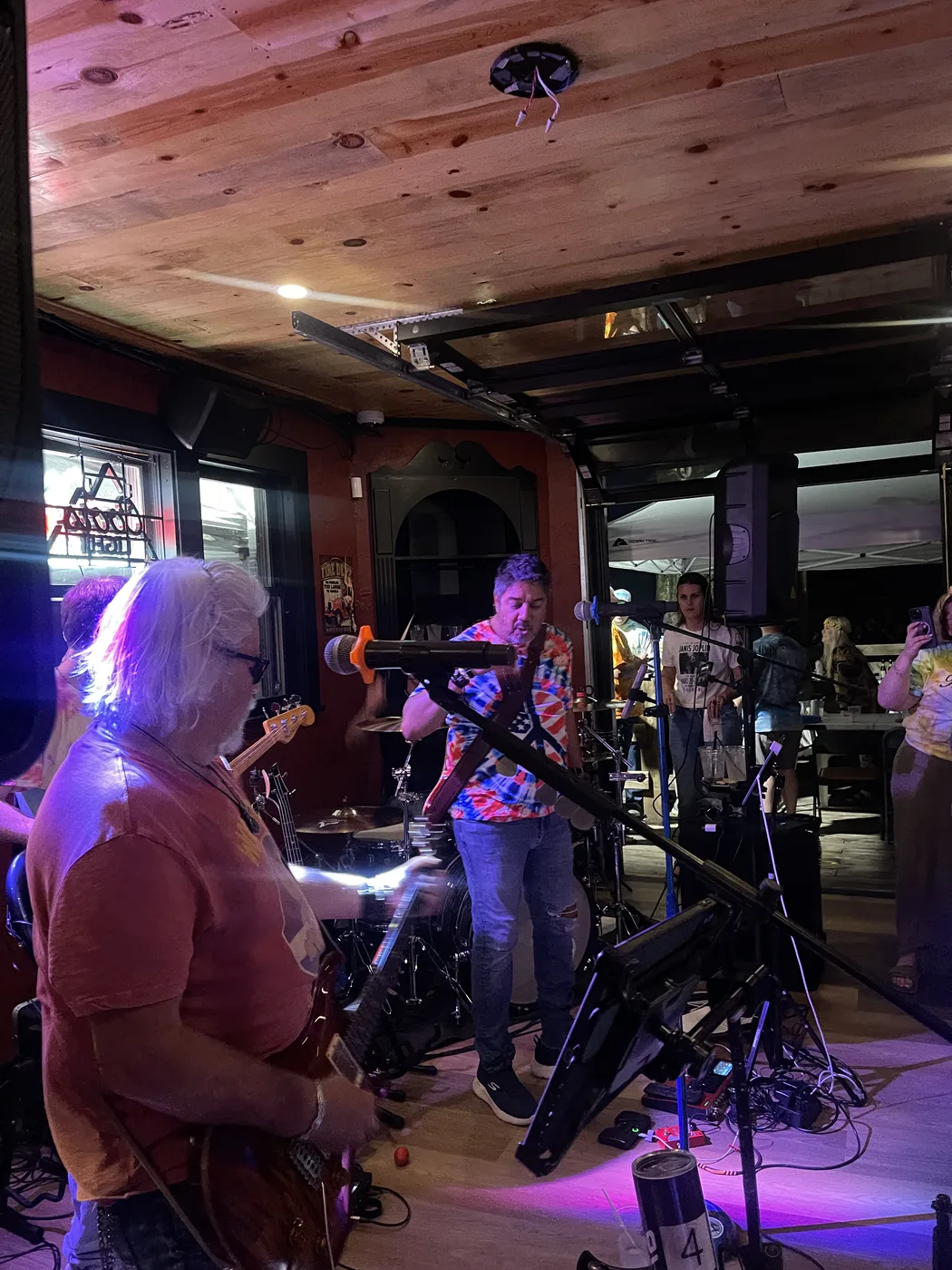 The band performing under colorful stage lights