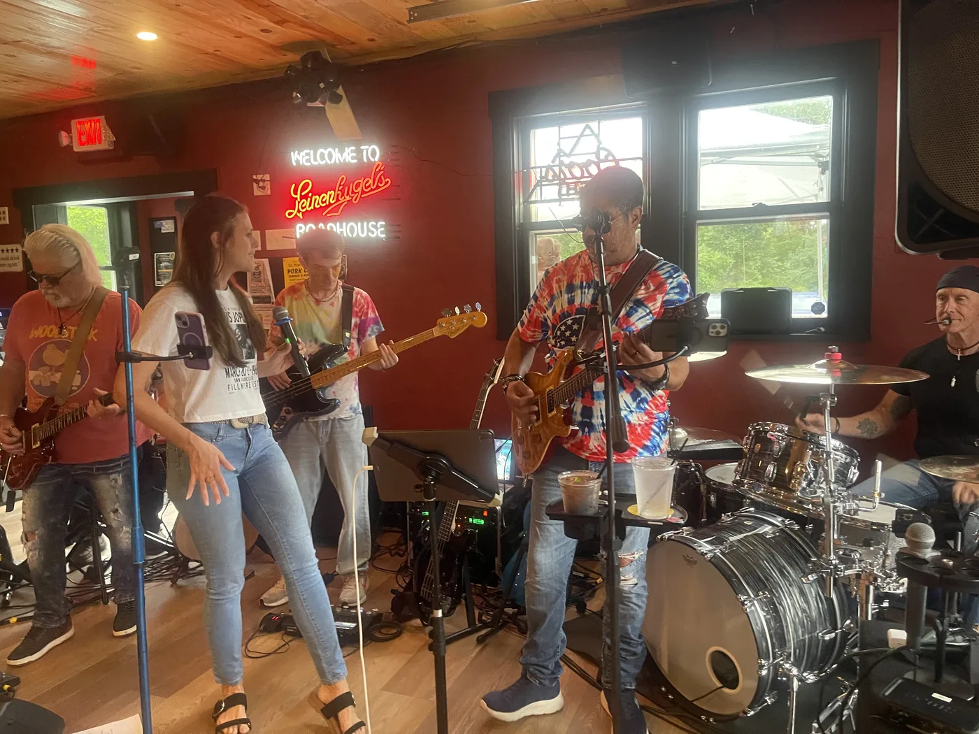Band members playing guitar and singing live